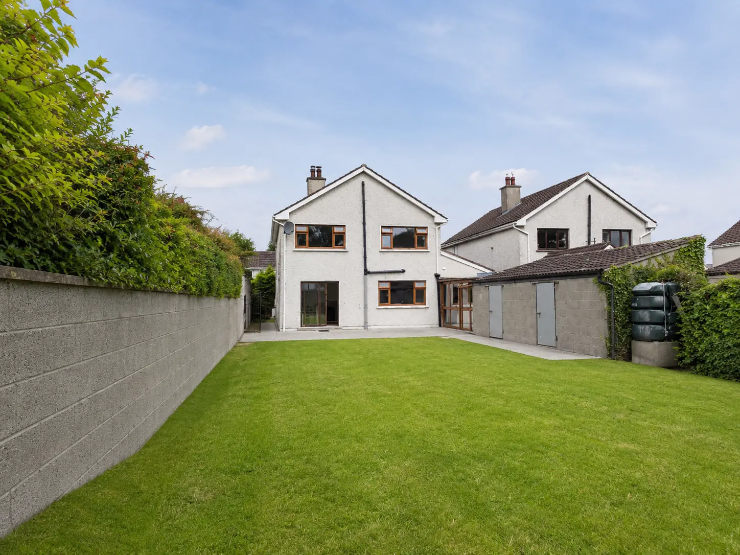 Rear garden and white two-storey house at 104 Newpark
